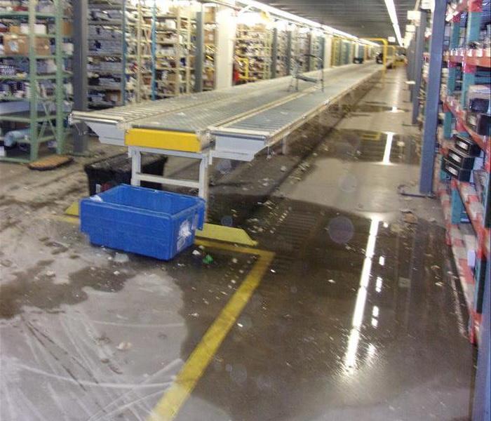 Water on floor in large warehouse.
