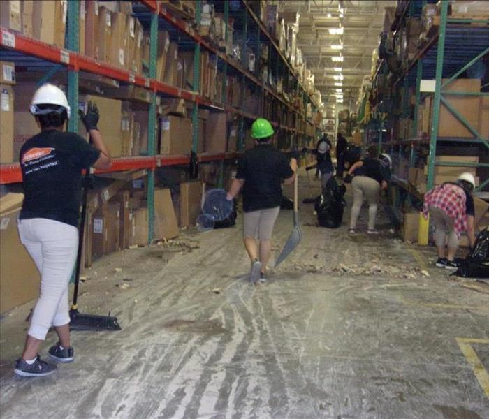 SERVPRO team members in action cleaning up a warehouse.